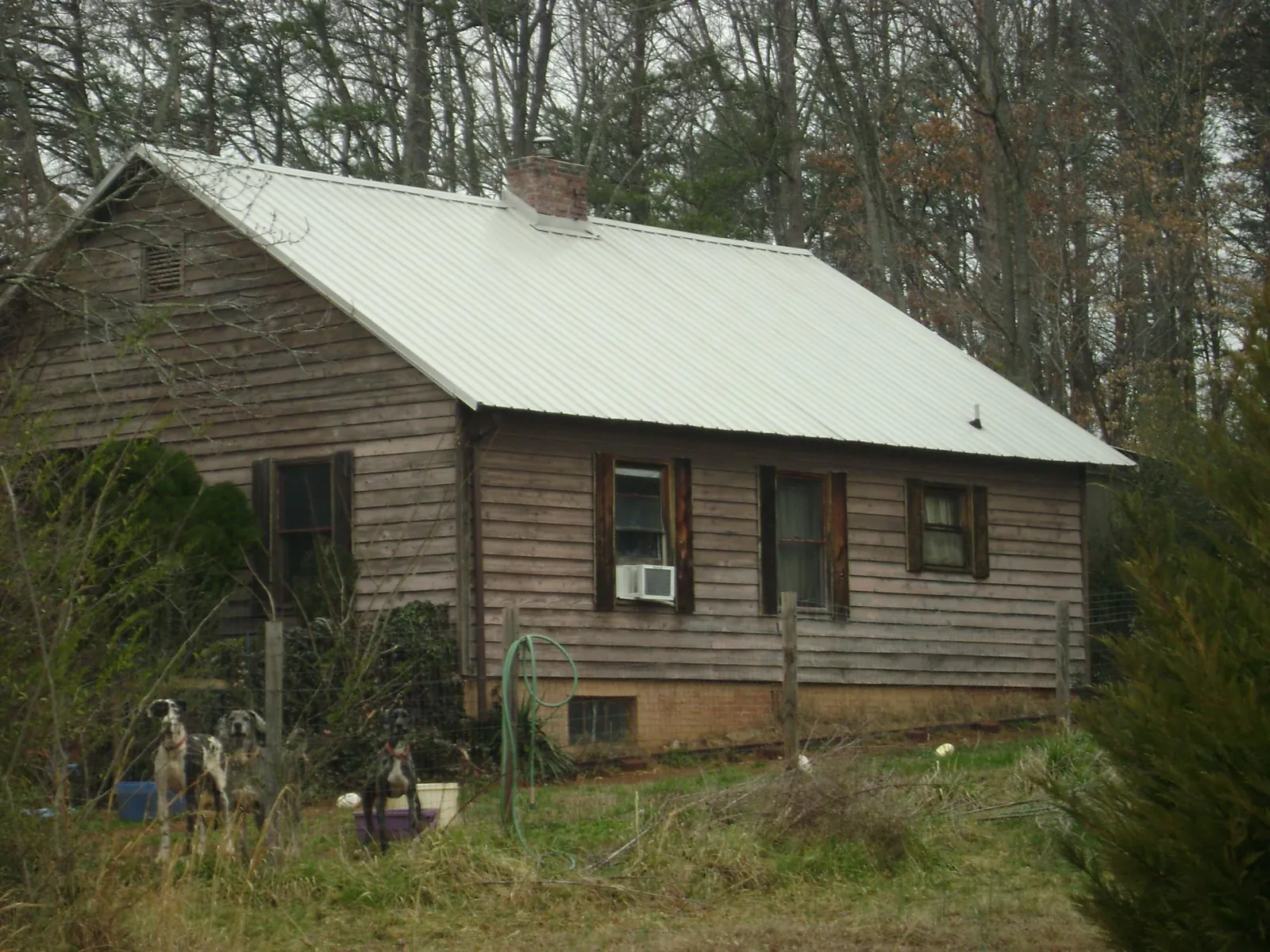 White metal roof on an old wood sided farmhouse, from a Metal Roof Installation job in Misenheimer